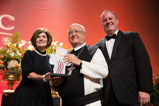 Fr. Abbot Dennis (middle) receives the award from Vicky Lattner (left) and Matt Kramer (right). (Image from https://flic.kr/p/EpLw5L)