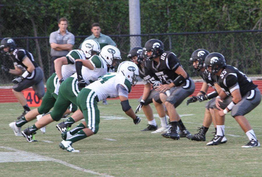 The Hawks offensive line protects against the Kinghts defense. (Photo by Matt Harris)